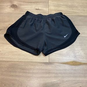 Grey and Black Nike track shorts.